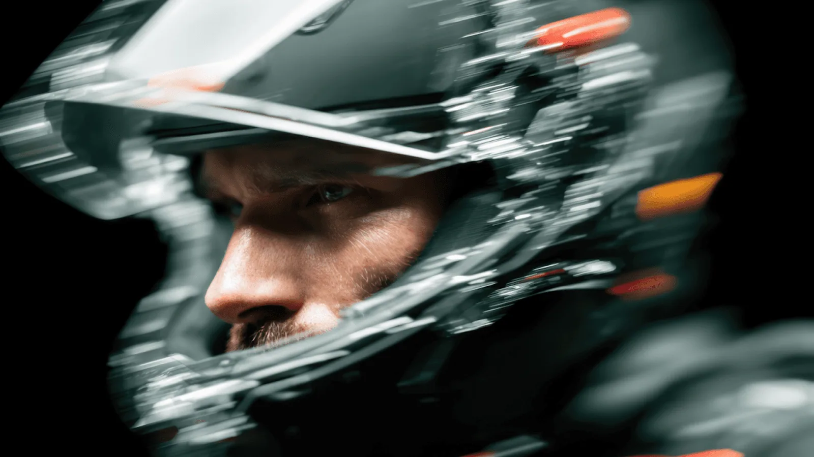 Close-up of a helmeted rider with motion blur